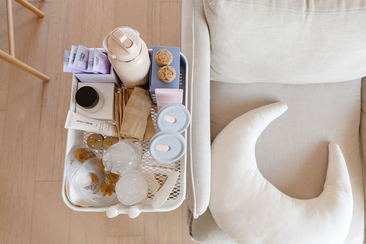 A white couch with a tray full of coffee, tea, and snacks.