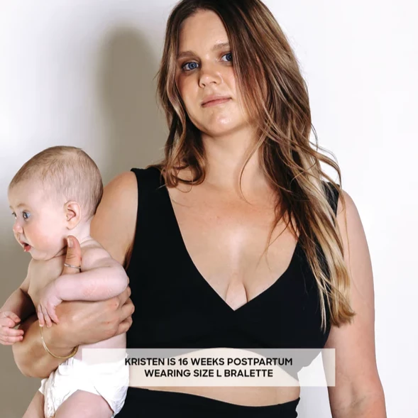 Image of a postpartum mother holding a baby wearing a Bare Mum Bralette.